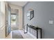 Bright entryway with a blue door and modern console table at 7783 Westland Dr, Kissimmee, FL 34747