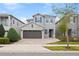 Two-story house with gray siding, stone accents, and a brown garage door at 7783 Westland Dr, Kissimmee, FL 34747