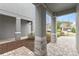 Covered front porch with stone columns and a brick paved walkway at 7783 Westland Dr, Kissimmee, FL 34747