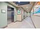 Clean and bright hallway with elevator access and artwork at 7783 Westland Dr, Kissimmee, FL 34747