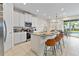 Modern kitchen with white cabinets, stainless steel appliances and breakfast bar at 7783 Westland Dr, Kissimmee, FL 34747