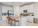 Modern kitchen with white cabinets, stainless steel appliances, and an island with seating at 7783 Westland Dr, Kissimmee, FL 34747