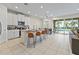 Open floorplan with kitchen, living room, and pool view at 7783 Westland Dr, Kissimmee, FL 34747