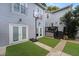 Inviting backyard with synthetic turf, patio, and a basketball hoop perfect for outdoor activities at 810 E Central Blvd, Orlando, FL 32801