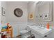 Stylish bathroom with pedestal sink, white subway tile, and dark vanity at 810 E Central Blvd, Orlando, FL 32801