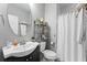 Cozy bathroom featuring a sink, a white shower curtain, and an oval mirror at 810 E Central Blvd, Orlando, FL 32801