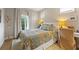 Comfortable bedroom with natural light, a cozy quilt, and light hardwood floors at 810 E Central Blvd, Orlando, FL 32801