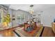Charming dining area with a glass table, mid-century chairs, and hardwood floors at 810 E Central Blvd, Orlando, FL 32801