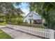 Gray house with white picket fence, well-manicured lawn, and walkway at 810 E Central Blvd, Orlando, FL 32801