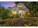 Charming home exterior with beautiful landscaping, mature trees, and welcoming front porch at 810 E Central Blvd, Orlando, FL 32801