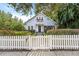 Light blue house with white picket fence and gate, charming landscaping at 810 E Central Blvd, Orlando, FL 32801