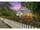 Quaint home showcasing a white picket fence, lush greenery and inviting front porch at 810 E Central Blvd, Orlando, FL 32801