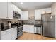 Modern kitchen with white cabinets and stainless steel appliances at 810 E Central Blvd, Orlando, FL 32801