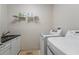 Functional laundry room with modern washer and dryer units, and granite sink top at 810 E Central Blvd, Orlando, FL 32801