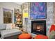 Cozy living room featuring a fireplace, sectional sofa, and large artwork at 810 E Central Blvd, Orlando, FL 32801