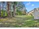 Private backyard with grassy area and mature trees at 8177 Roseville Blvd, Davenport, FL 33896