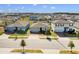 Aerial view of three houses in a new suburban neighborhood at 841 Teton St, Haines City, FL 33844