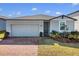 Gray house with a two-car garage and nicely landscaped yard at 841 Teton St, Haines City, FL 33844