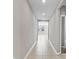 Clean hallway with tile flooring and doors to other rooms at 841 Teton St, Haines City, FL 33844