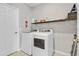 Laundry room with washer, dryer, and shelving at 841 Teton St, Haines City, FL 33844