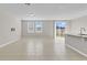 Open living room and kitchen with tile floors and sliding glass door at 841 Teton St, Haines City, FL 33844