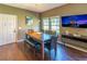 Dining room features wood floors and a large TV at 8923 Shine Dr, Kissimmee, FL 34747