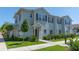 Two story light blue townhome with landscaping at 8923 Shine Dr, Kissimmee, FL 34747