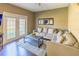 Living room with beige couch and access to backyard at 8923 Shine Dr, Kissimmee, FL 34747