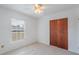 Bedroom with wood sliding doors and neutral walls at 1006 Center St, Ocoee, FL 34761