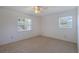 Spacious bedroom with two windows and ceiling fan at 1006 Center St, Ocoee, FL 34761