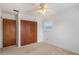 Bedroom with double door closet and ceiling fan at 1006 Center St, Ocoee, FL 34761