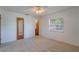 Bedroom with mirrored closet door and ceiling fan at 1006 Center St, Ocoee, FL 34761