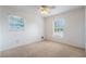 Bright bedroom with ceiling fan, carpet, and ample window light at 1006 Center St, Ocoee, FL 34761