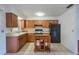 Efficient kitchen, featuring wood cabinets and black appliances at 1006 Center St, Ocoee, FL 34761