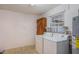 Laundry room with washer, dryer, and wooden accents at 1006 Center St, Ocoee, FL 34761