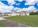 Tan one-story house with a two-car garage and manicured lawn at 1101 James Ave, Deltona, FL 32738