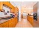 Well-lit kitchen with stainless steel appliances, tiled floor and ample cabinet space at 1101 James Ave, Deltona, FL 32738