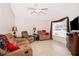 Cozy living room showcasing neutral decor, tile flooring, and plenty of natural light at 1101 James Ave, Deltona, FL 32738