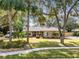 House with mature landscaping and long driveway at 1107 Pheasant Cir, Winter Springs, FL 32708