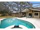 Inviting kidney-shaped pool with a spa and screened enclosure at 1107 Pheasant Cir, Winter Springs, FL 32708