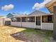 View of the backyard with a screened porch at 1119 Pine Ave, Tavares, FL 32778