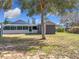 Backyard with house and shed; sunny day at 1119 Pine Ave, Tavares, FL 32778