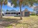 Backyard view showing house and shed at 1119 Pine Ave, Tavares, FL 32778