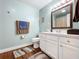 Clean bathroom with light teal walls and white vanity at 1119 Pine Ave, Tavares, FL 32778