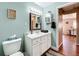 Clean bathroom with light teal walls and white vanity at 1119 Pine Ave, Tavares, FL 32778