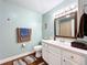 Clean bathroom with light teal walls and white vanity at 1119 Pine Ave, Tavares, FL 32778