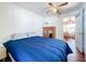 Spacious bedroom with a blue comforter and access to another room at 1119 Pine Ave, Tavares, FL 32778