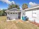 White garage door with two chairs in front at 1119 Pine Ave, Tavares, FL 32778