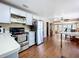 Kitchen with stainless steel appliances, white cabinets, and wood-look floors at 1119 Pine Ave, Tavares, FL 32778