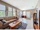 Bright living room featuring a brown sofa, coffee table, and tiled floors at 1119 Pine Ave, Tavares, FL 32778